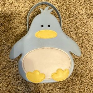 Penguin blue/yellow/white ring and trinket holder with handle.  Snaps closed.